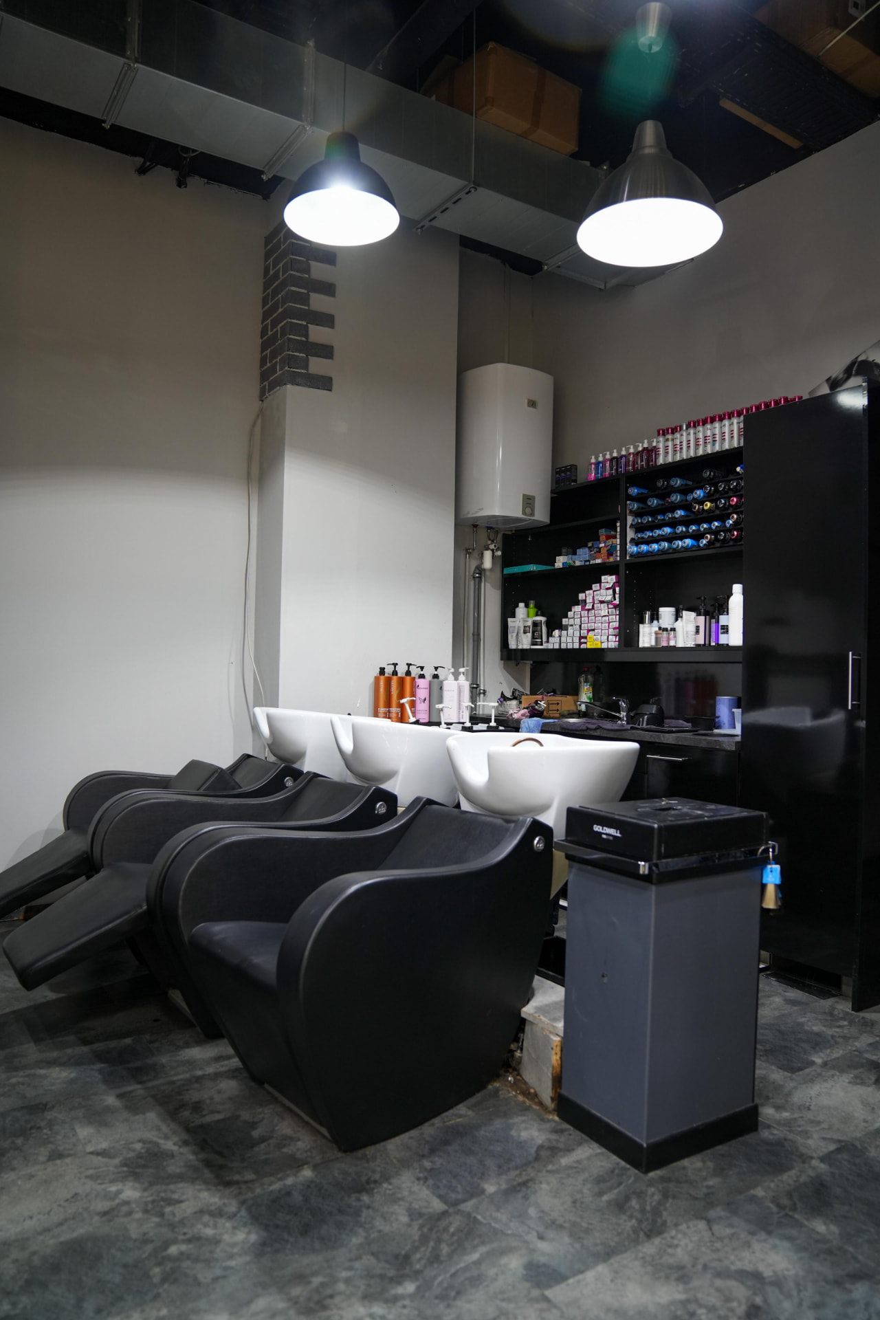Waschbereich mit schwarzen Liegen im AZARA Salon